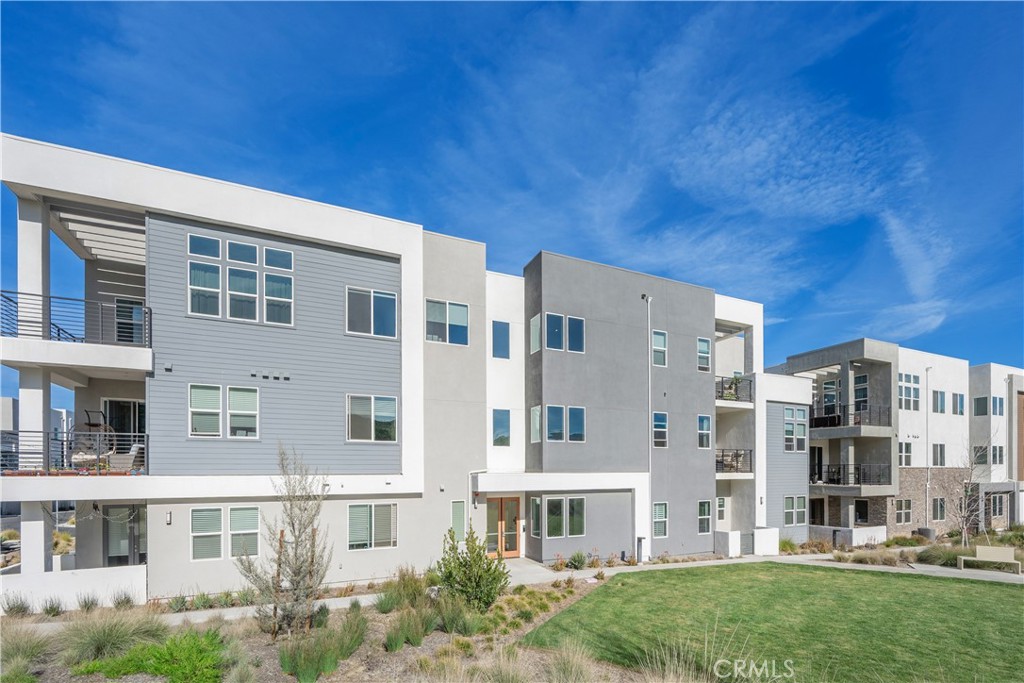 27225 Cranmore Way, Unit 101 Valencia, CA 91381 - Photo 27 of 36 a large building with a yard