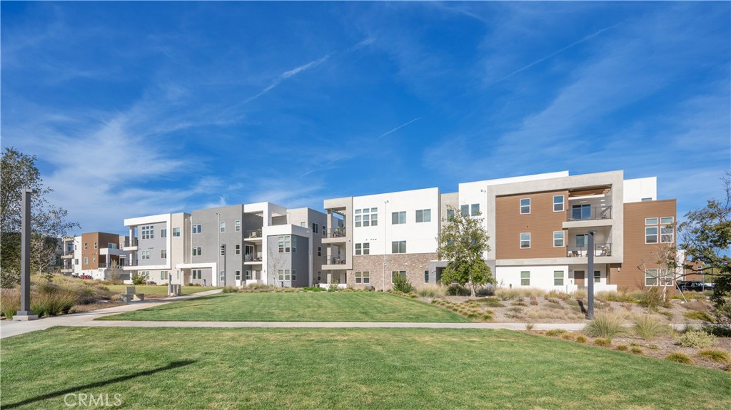 27225 Cranmore Way, Unit 101 Valencia, CA 91381 - Photo 29 of 36 a view of big building with a yard