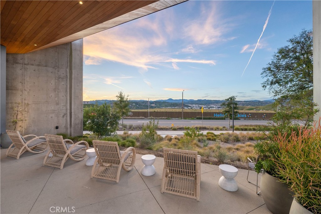 27225 Cranmore Way, Unit 101 Valencia, CA 91381 - Photo 31 of 36 a view of a terrace with lawn chairs and iron fence