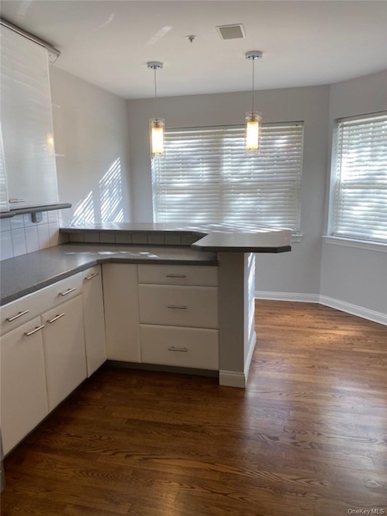 51 Winding Ridge Road White Plains, NY 10603 - Photo 10 of 30 a kitchen with a sink and wooden floor