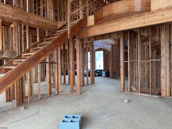 a view of staircase with railing and white walls