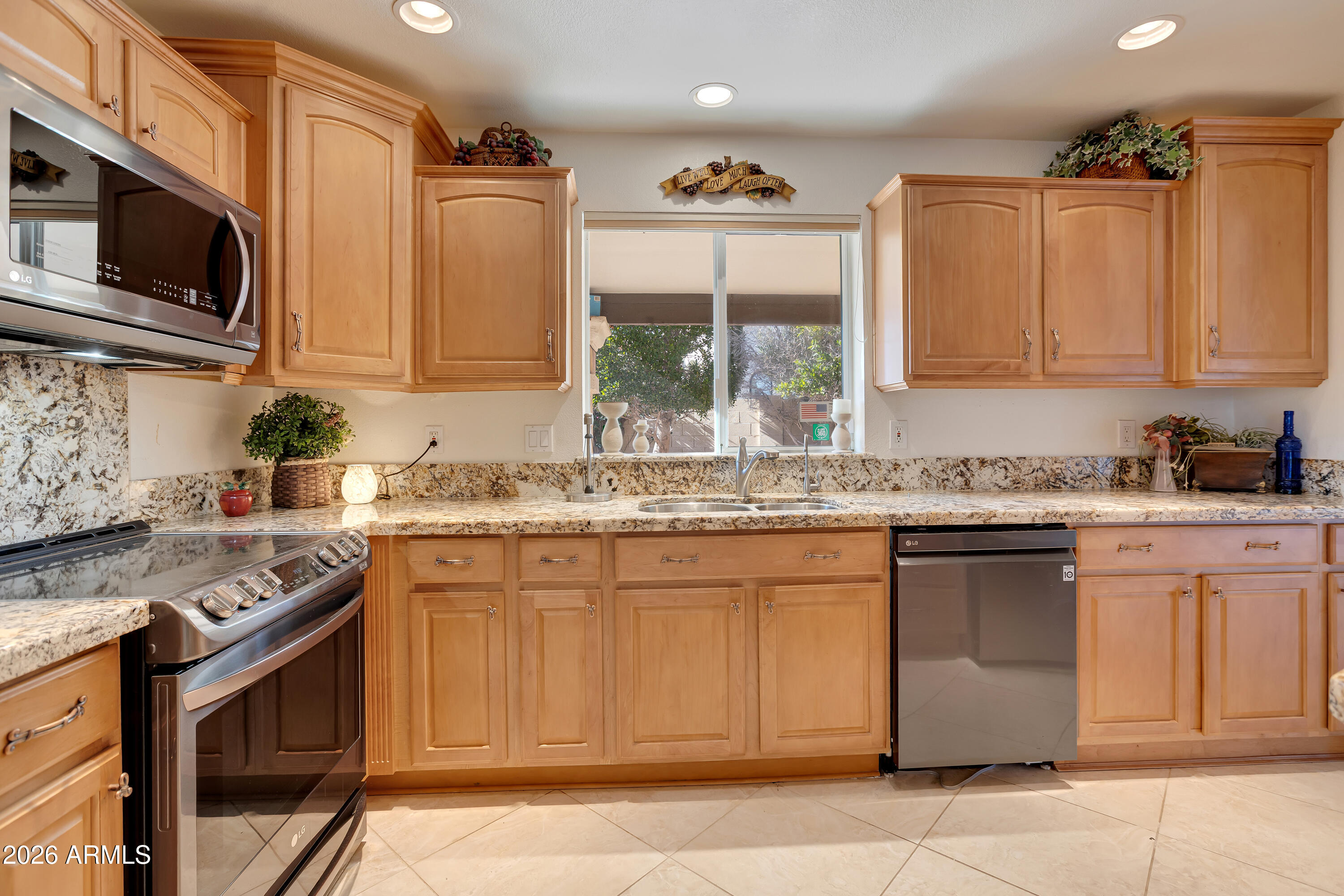 4610 East Monte Way Phoenix, AZ 85044 - Photo 13 of 44 a kitchen with stainless steel appliances granite countertop a sink stove and microwave