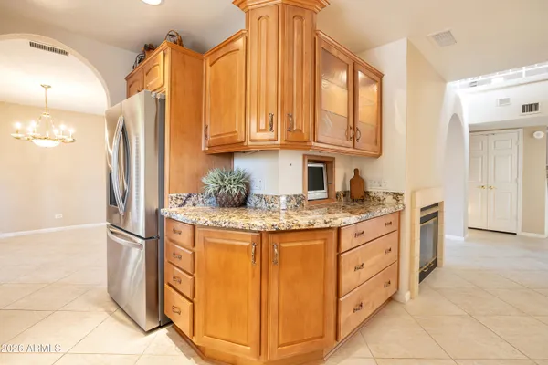 a kitchen with stainless steel appliances granite countertop a refrigerator and a stove