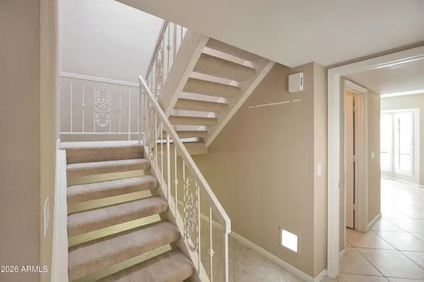 a view of staircase with white walls and a next to a window