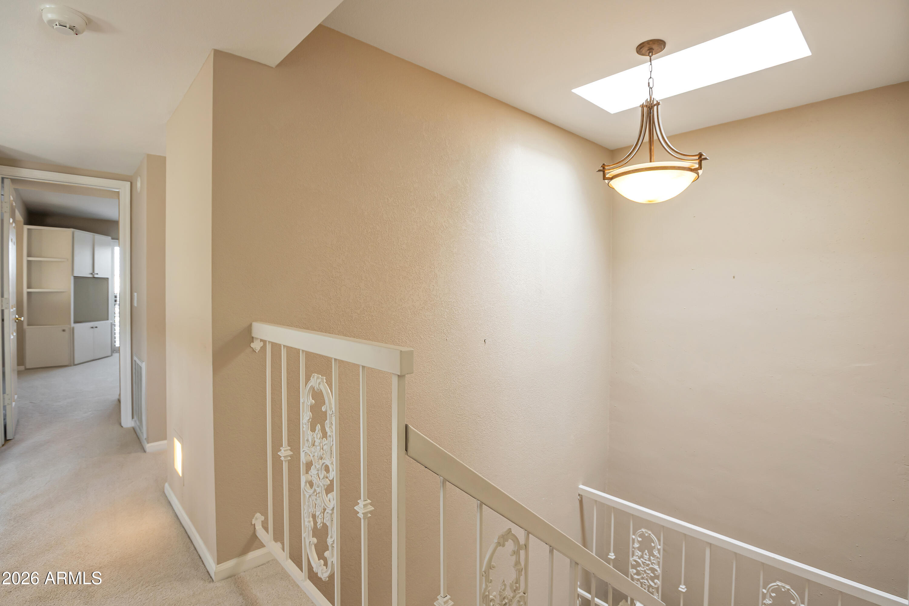 4610 East Monte Way Phoenix, AZ 85044 - Photo 19 of 44 a view of a hallway with a chandelier fan