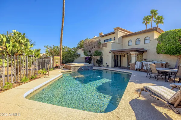 a view of a house with swimming pool and sitting area