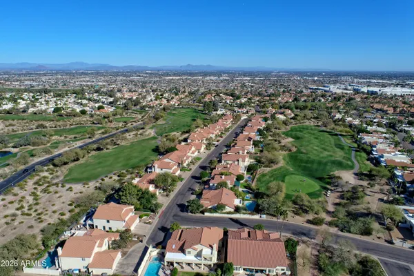 an aerial view of residential houses and outdoor space