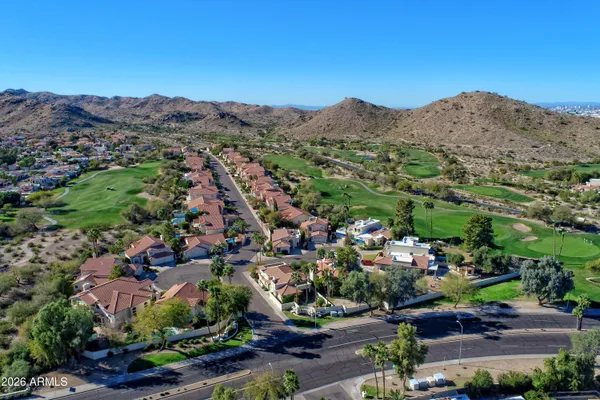 an aerial view of a house with garden space and street view
