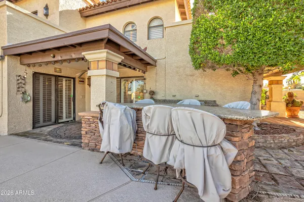 a view of a porch with chairs and potted plants