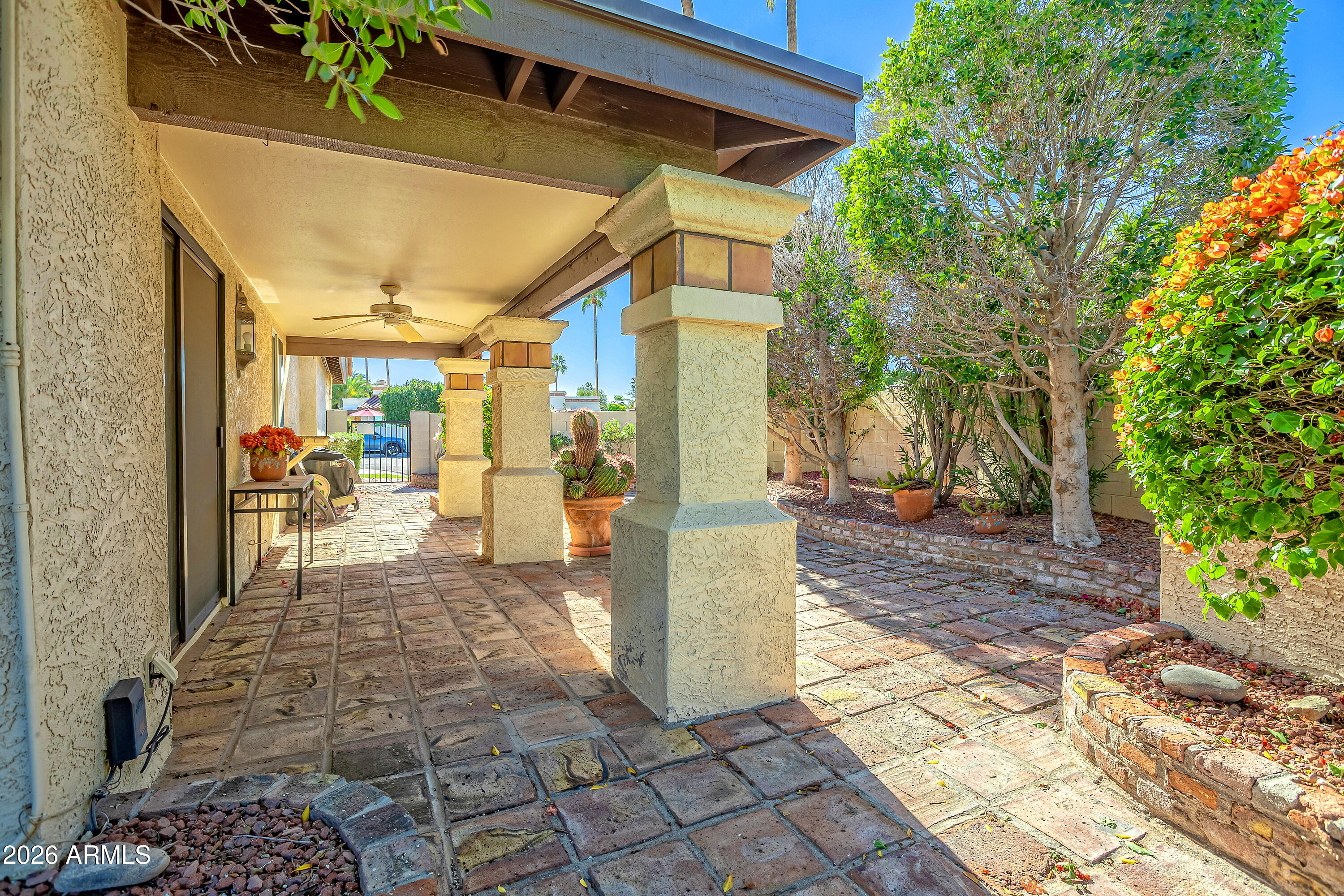 4610 East Monte Way Phoenix, AZ 85044 - Photo 42 of 44 a view of a porch with chairs and potted plants