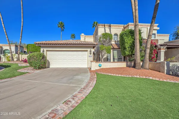 a view of a house with a yard and table