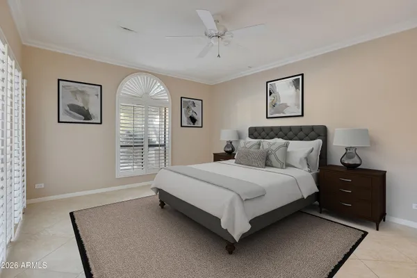 a spacious bedroom with a bed and a window