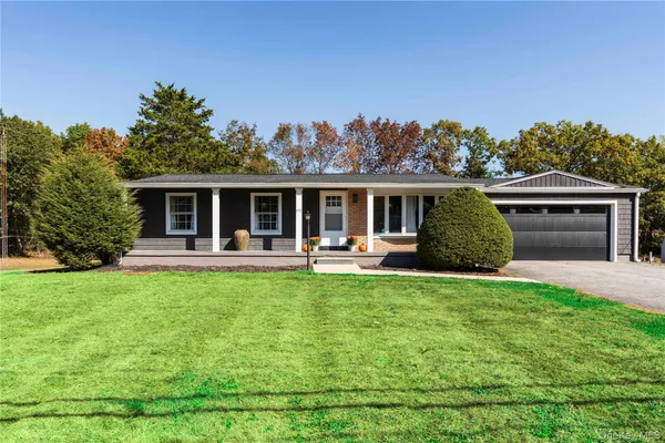 a front view of a house with yard porch and furniture