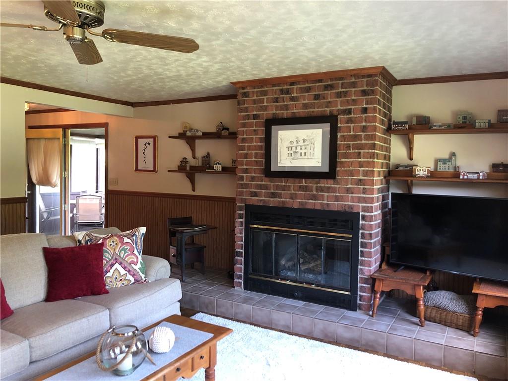230 Locust Road Addison, PA 15411 - Photo 14 of 43 a living room with furniture a flat screen tv and a fireplace