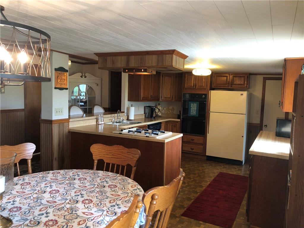 230 Locust Road Addison, PA 15411 - Photo 21 of 43 a kitchen with a sink and a refrigerator
