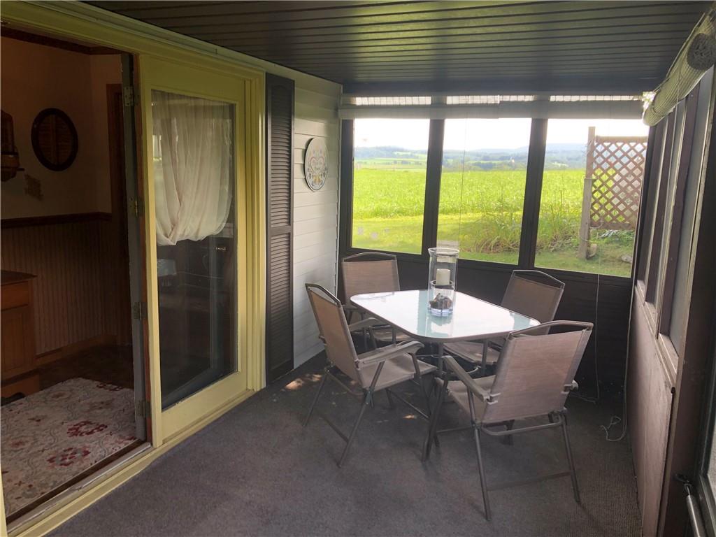 230 Locust Road Addison, PA 15411 - Photo 10 of 43 a table and chairs in front of a glass door