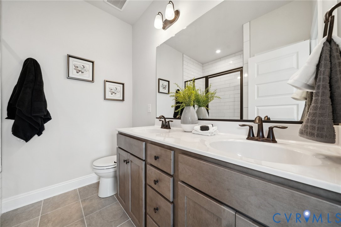 16116 Esteem Way Midlothian, VA 23113 - Photo 21 of 44 a bathroom with a double vanity sink and a mirror