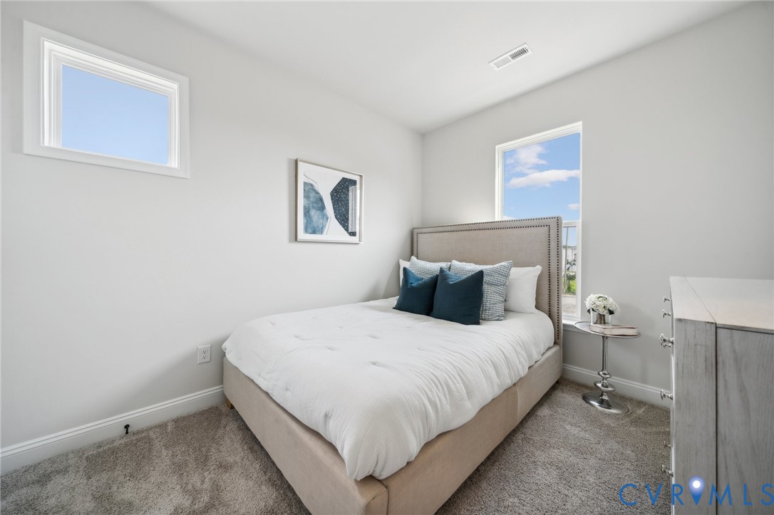 16116 Esteem Way Midlothian, VA 23113 - Photo 25 of 44 a bedroom with a bed and a wall painting