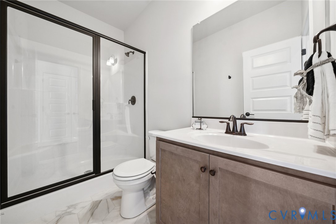 16116 Esteem Way Midlothian, VA 23113 - Photo 26 of 44 a bathroom with a granite countertop sink toilet a mirror and shower