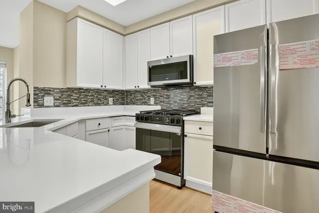a kitchen with a sink stove and refrigerator