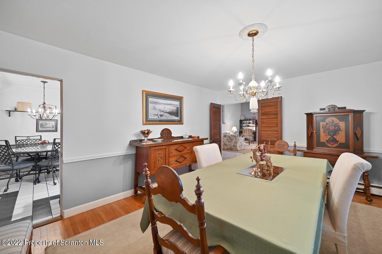 807 Layton Road Clarks Summit, PA 18411 - Photo 17 of 73 a view of a dining room with furniture and chandelier