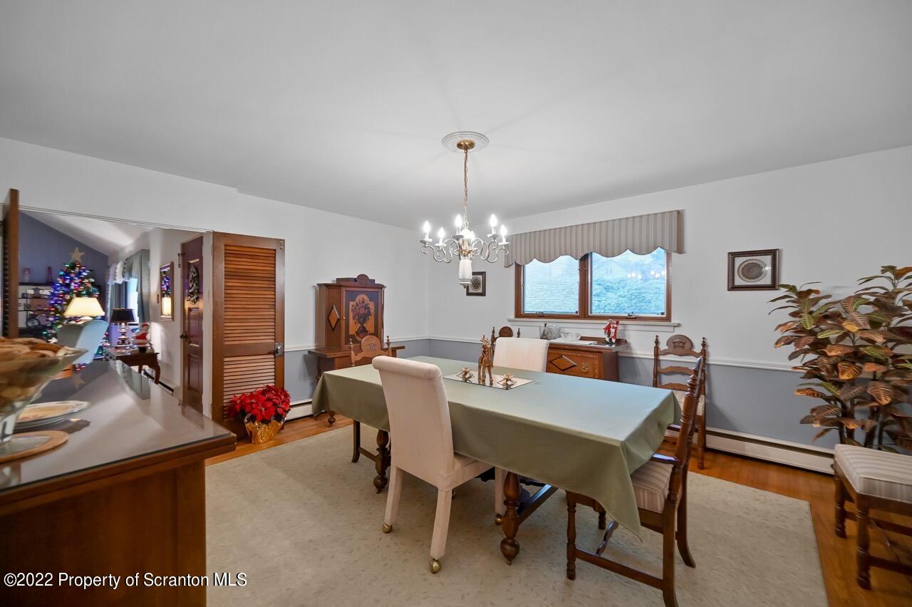 807 Layton Road Clarks Summit, PA 18411 - Photo 18 of 73 a view of a dining room with furniture and chandelier
