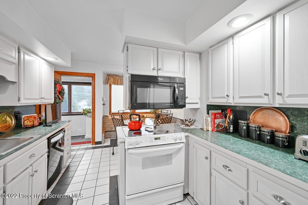 807 Layton Road Clarks Summit, PA 18411 - Photo 20 of 73 a kitchen with appliances a sink cabinets and a window