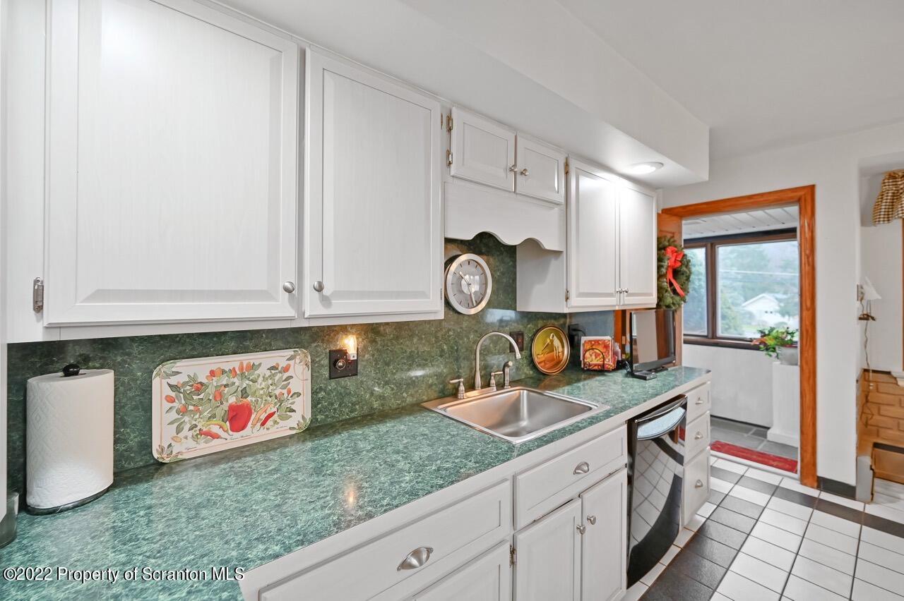 807 Layton Road Clarks Summit, PA 18411 - Photo 22 of 73 a kitchen with stainless steel appliances granite countertop a sink and a white cabinets