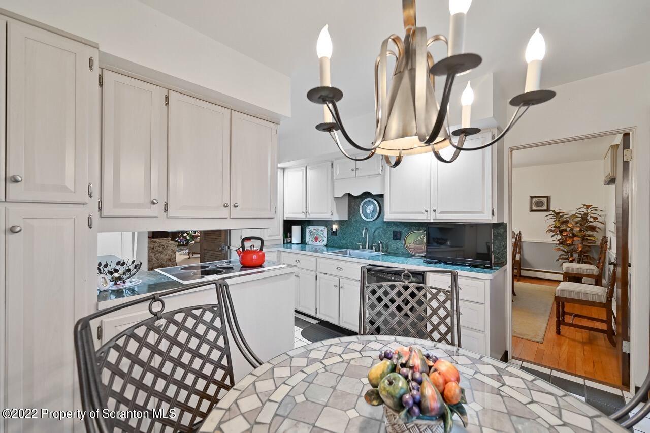 807 Layton Road Clarks Summit, PA 18411 - Photo 26 of 73 a kitchen with stainless steel appliances a sink a stove top oven a chimney and a center island