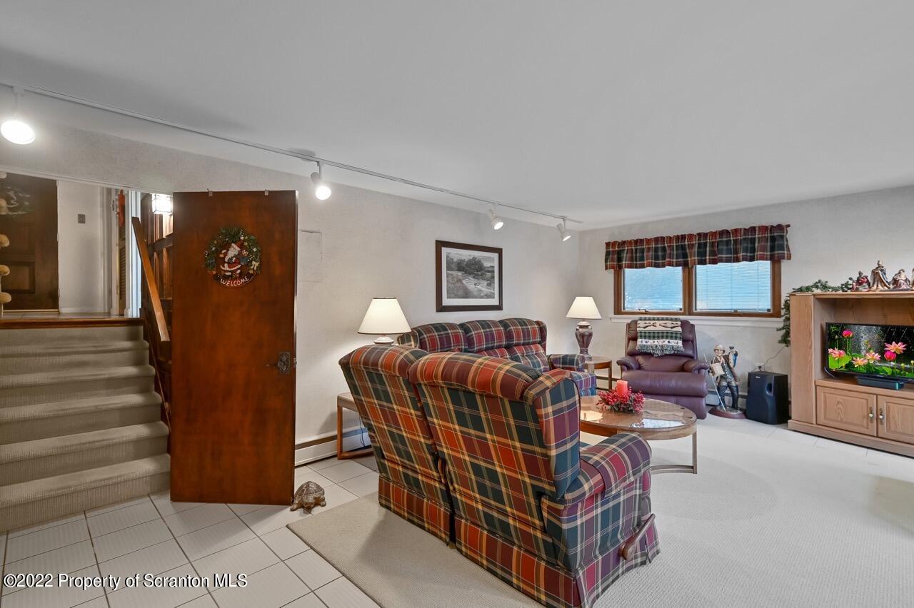 807 Layton Road Clarks Summit, PA 18411 - Photo 29 of 73 a living room with furniture and a flat screen tv