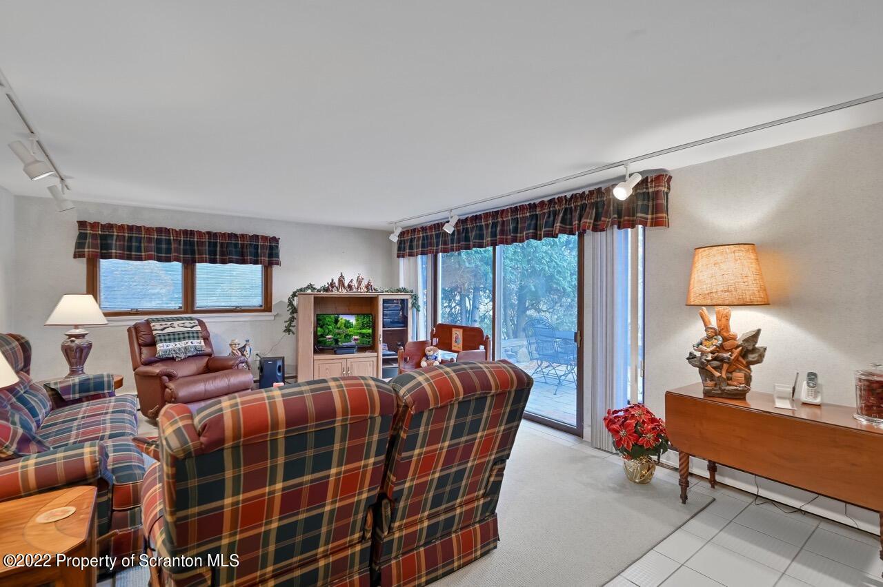 807 Layton Road Clarks Summit, PA 18411 - Photo 30 of 73 a living room with furniture a lamp and a potted plant