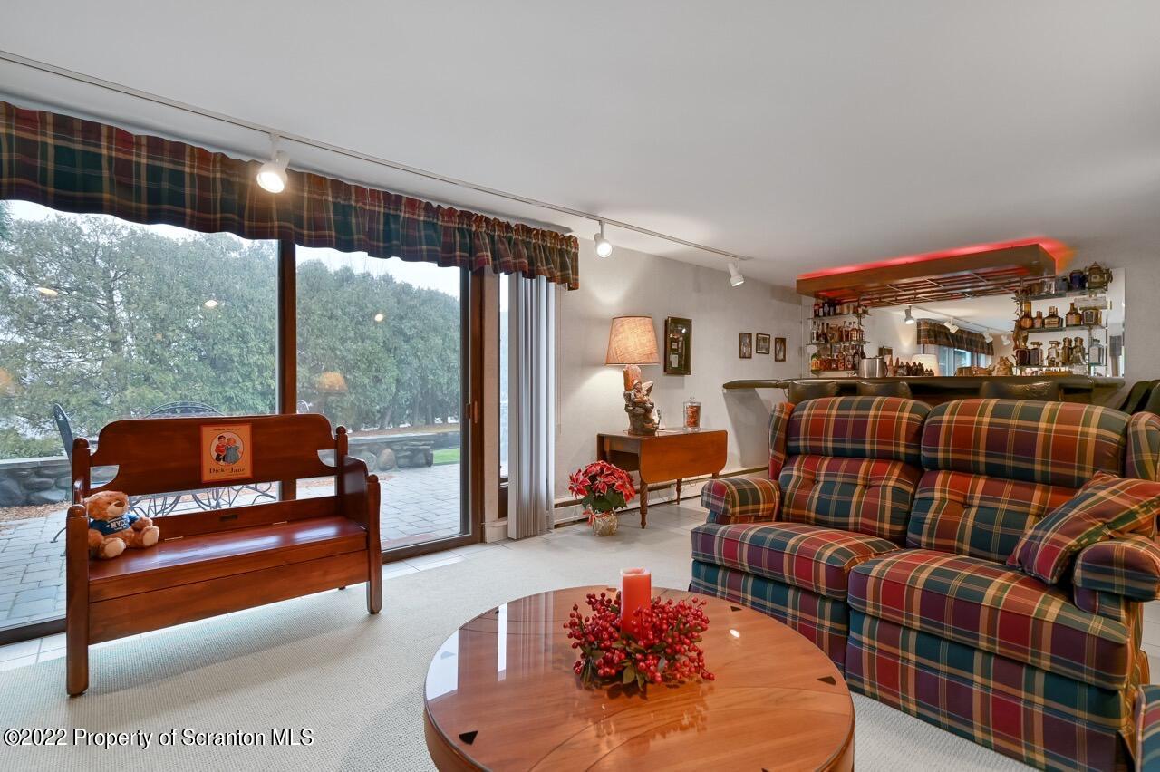 807 Layton Road Clarks Summit, PA 18411 - Photo 31 of 73 a bedroom with furniture and a floor to ceiling window