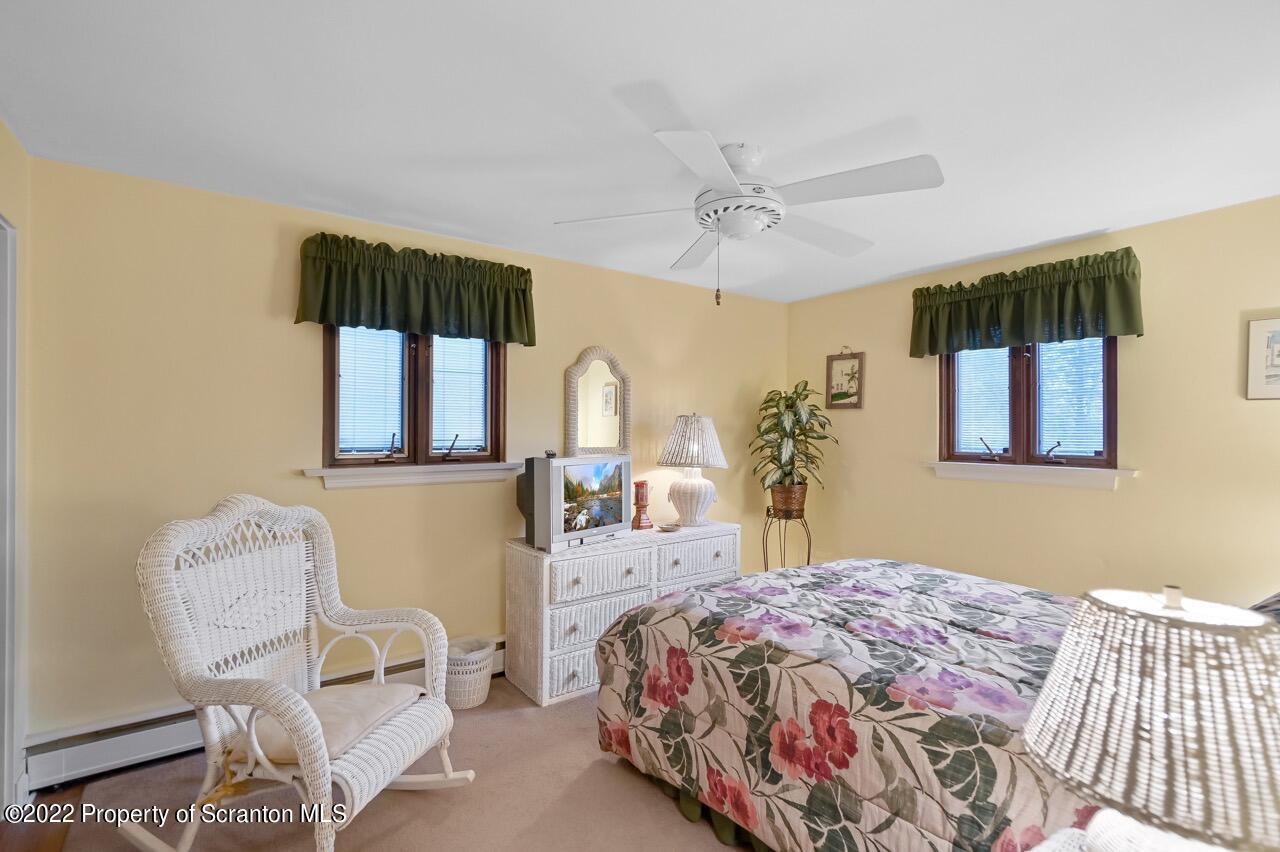 807 Layton Road Clarks Summit, PA 18411 - Photo 43 of 73 a bedroom with a bed a chair and potted plant