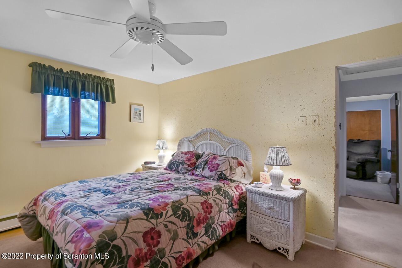 807 Layton Road Clarks Summit, PA 18411 - Photo 45 of 73 a bedroom with a bed and a chandelier