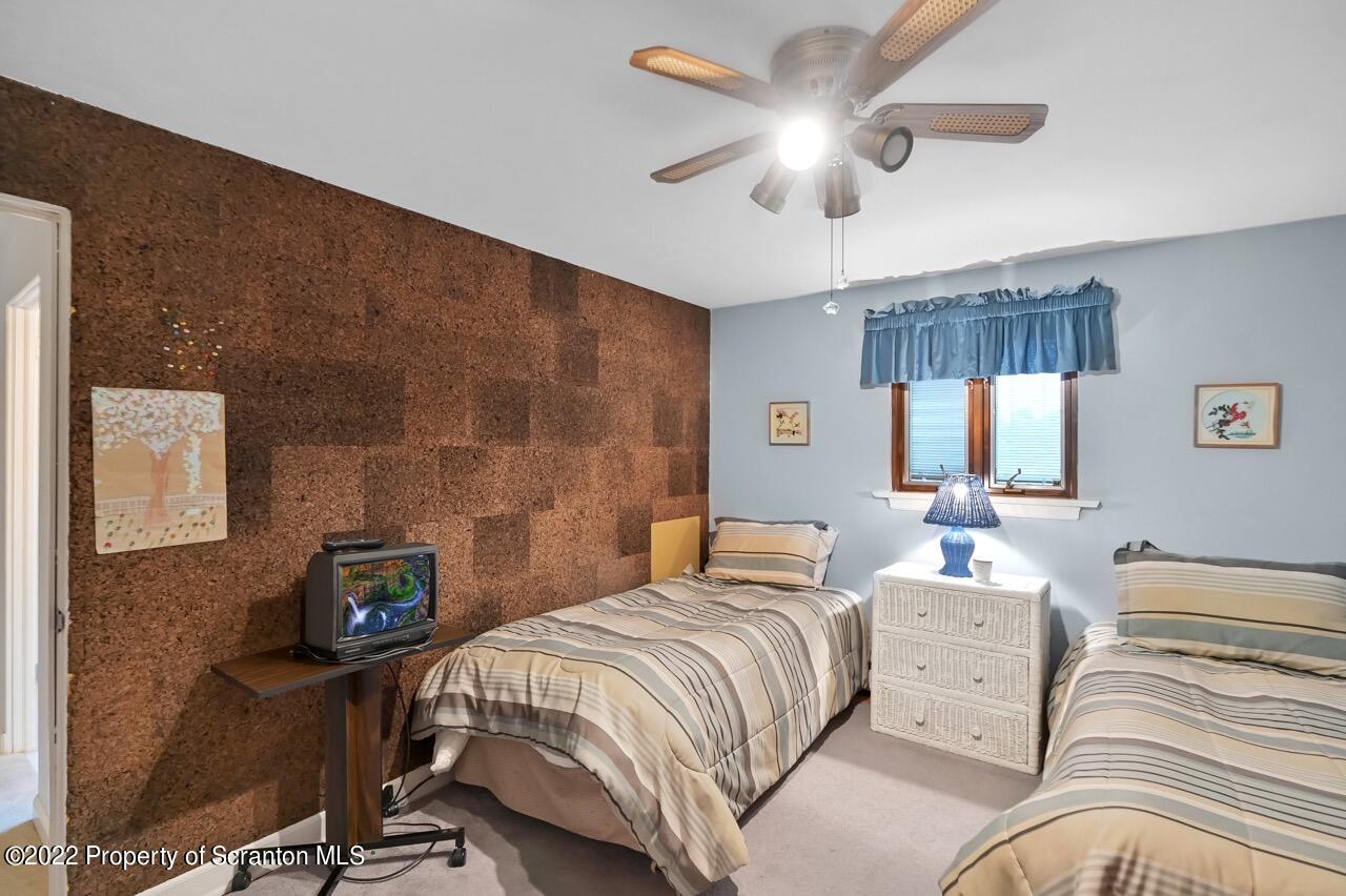 807 Layton Road Clarks Summit, PA 18411 - Photo 50 of 73 a bedroom with a bed and a chandelier