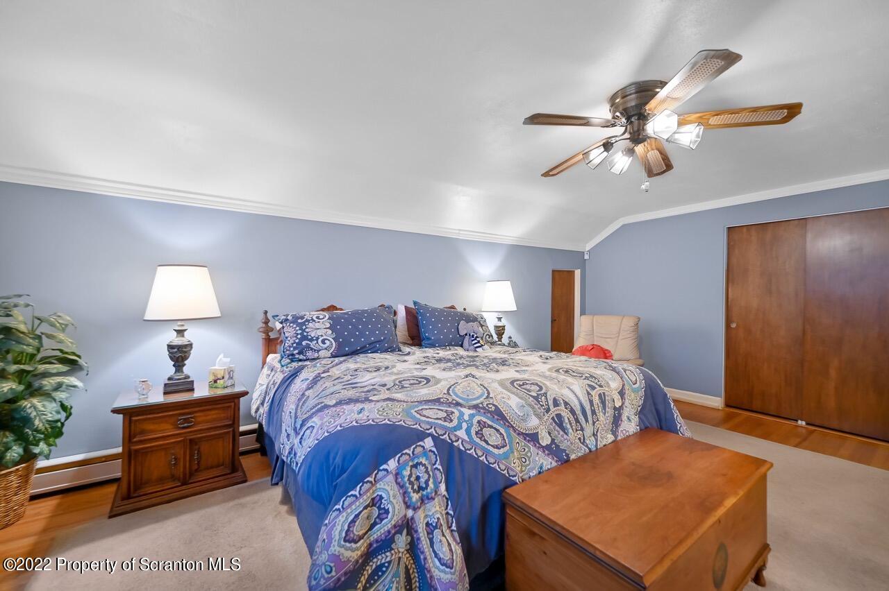 807 Layton Road Clarks Summit, PA 18411 - Photo 55 of 73 a bedroom with a bed and a chandelier