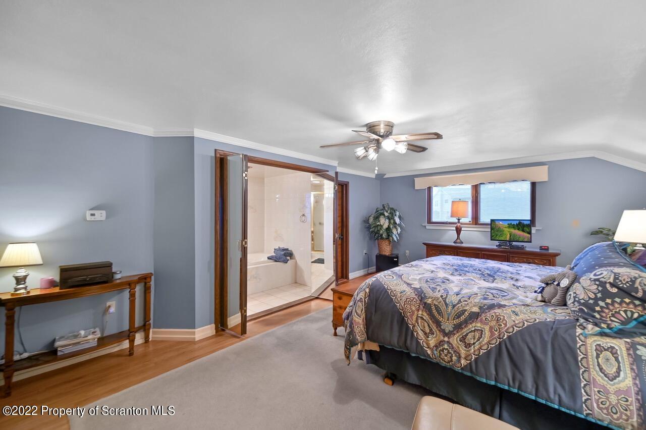 807 Layton Road Clarks Summit, PA 18411 - Photo 56 of 73 a bedroom with a bed and a chandelier