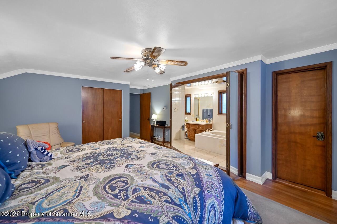807 Layton Road Clarks Summit, PA 18411 - Photo 57 of 73 a bedroom with a large bed and a chandelier