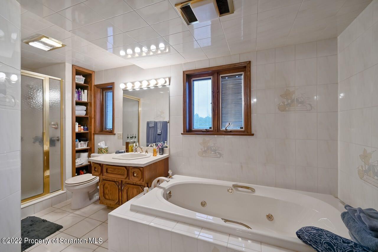 807 Layton Road Clarks Summit, PA 18411 - Photo 58 of 73 a bathroom with a bathtub sink and mirror