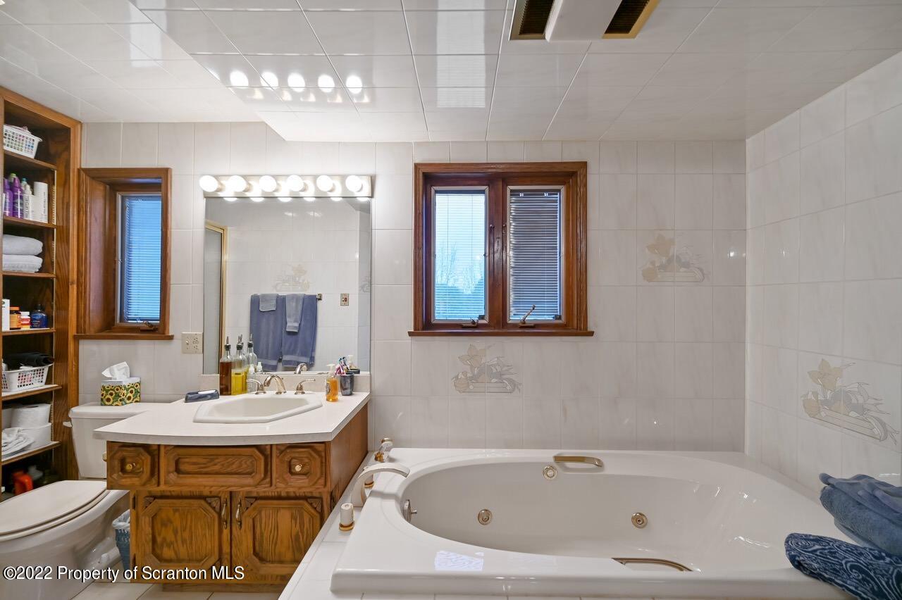 807 Layton Road Clarks Summit, PA 18411 - Photo 60 of 73 a bathroom with a sink and a mirror
