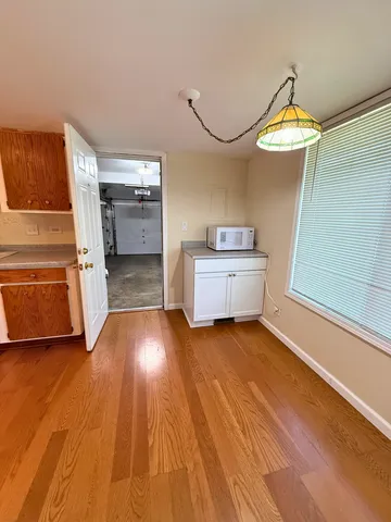 a view of a room with wooden floor stove and stairs
