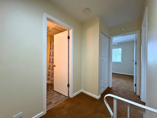 a view of an empty room and a ceiling fan