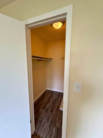 an empty room with a ceiling fan and window