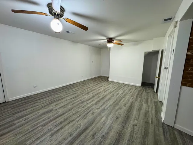 a view of a room with wooden floor