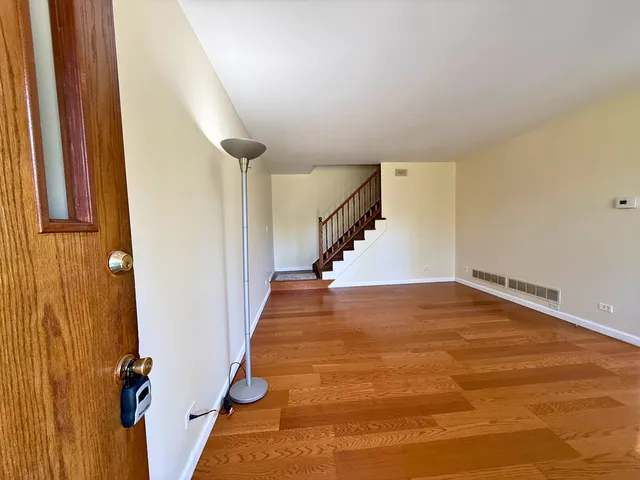 a view of a room with wooden floor and stairs