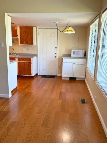 a kitchen with granite countertop a sink cabinets and stainless steel appliances
