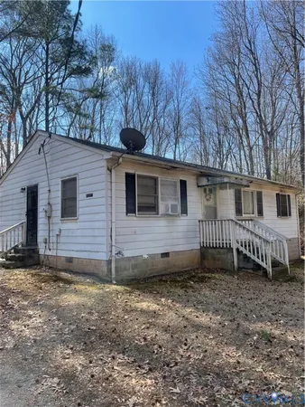 a view of a house with a yard and fence