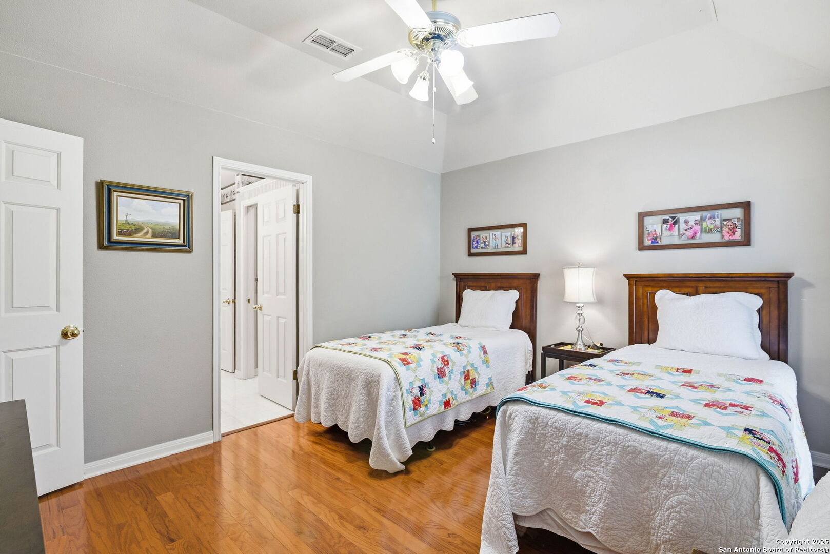 15 Inwood Point San Antonio, TX 78248 - Photo 18 of 27 a bedroom with two beds and a chandelier