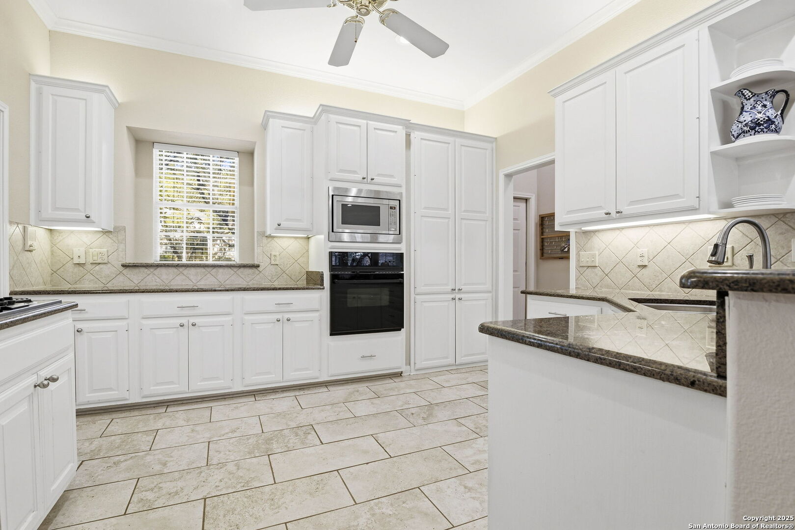 15 Inwood Point San Antonio, TX 78248 - Photo 7 of 27 a kitchen with kitchen island granite countertop a sink appliances cabinets and a counter top space