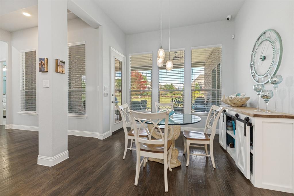 506 Life Spring Drive Rockwall, TX 75087 - Photo 15 of 36 a view of a dining room with furniture window and wooden floor